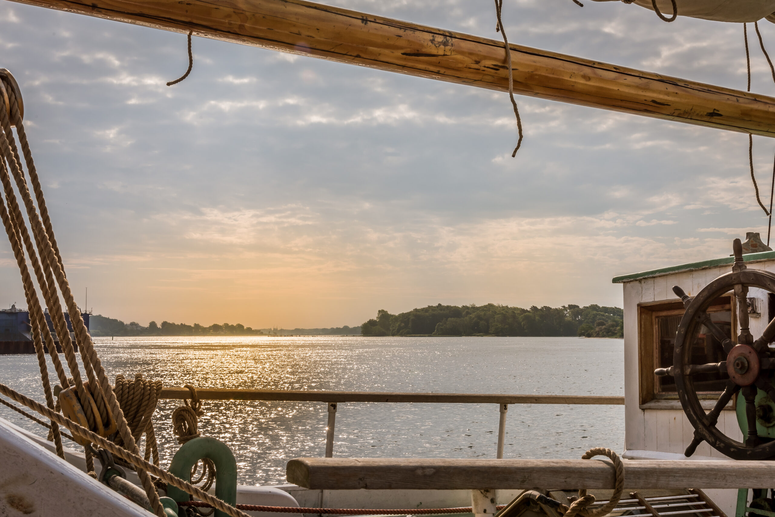 sunset seen through the rig of a salingboat south of the Danish island of Funen, July 13, 2019